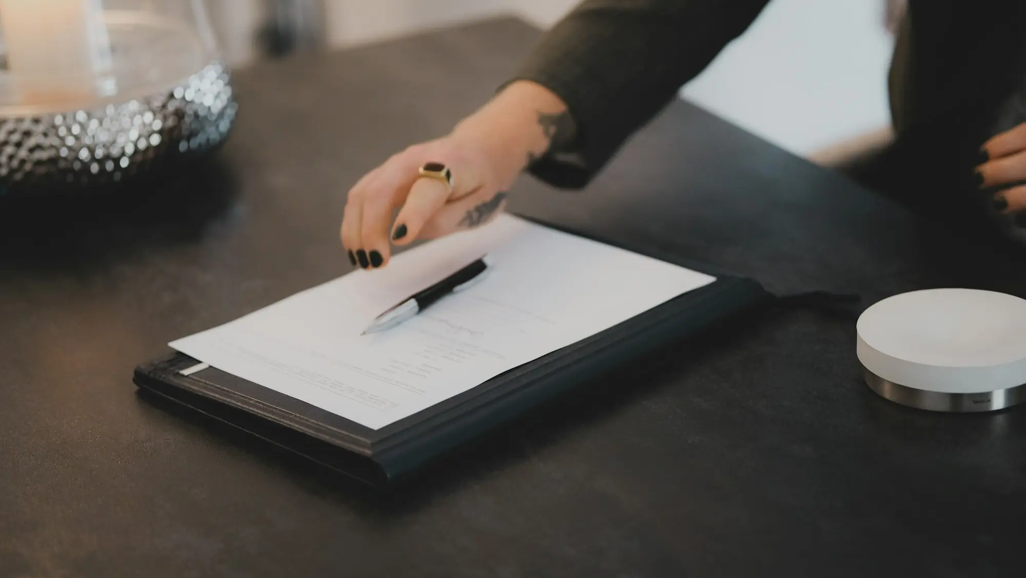 Director signing documents on a clipboard
