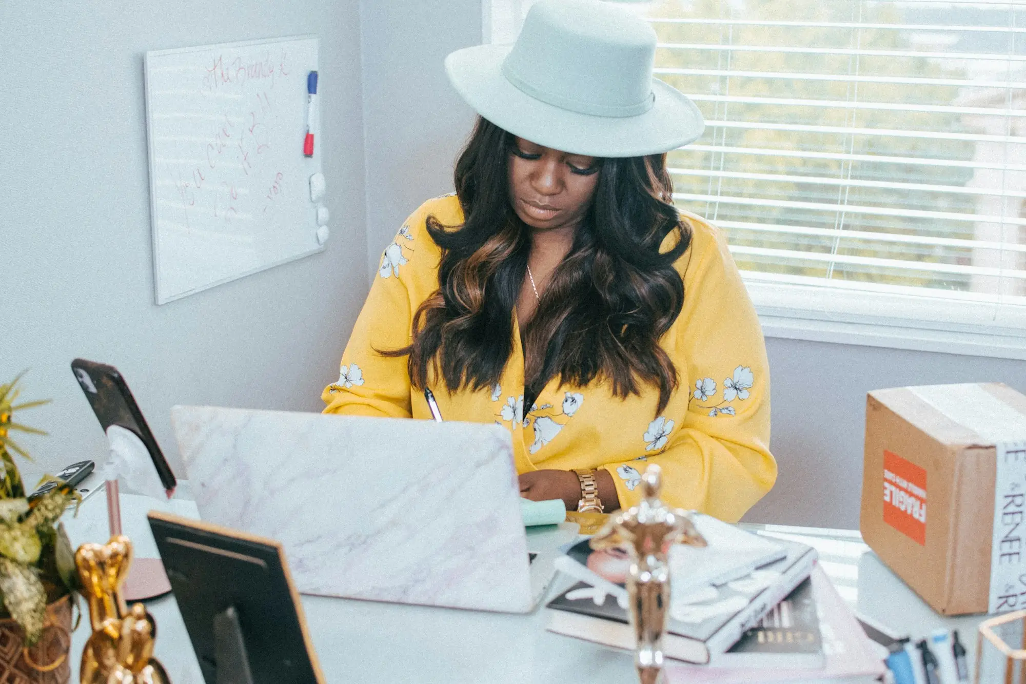 Online seller packing orders at her desk