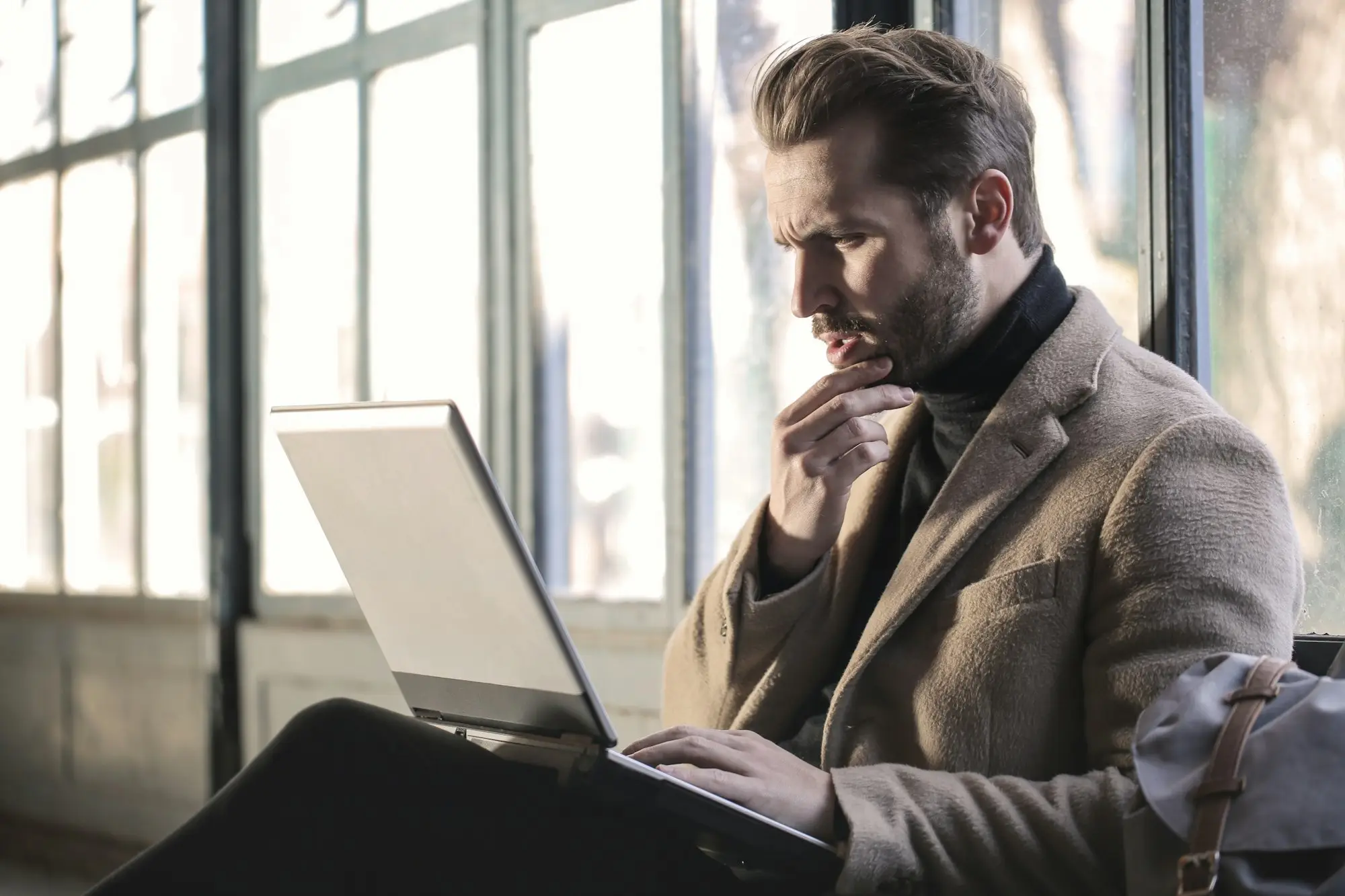 Business owner reviewing bank statements on a laptop